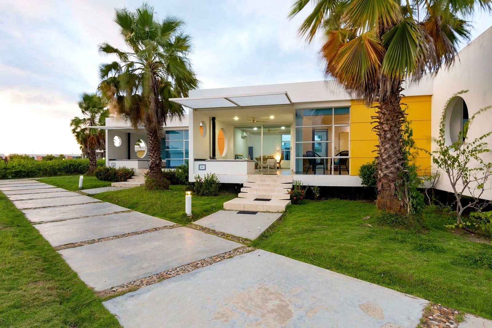 Modernas villas frente a la Marina Puerto Velero con palmeras y caminos de cemento.