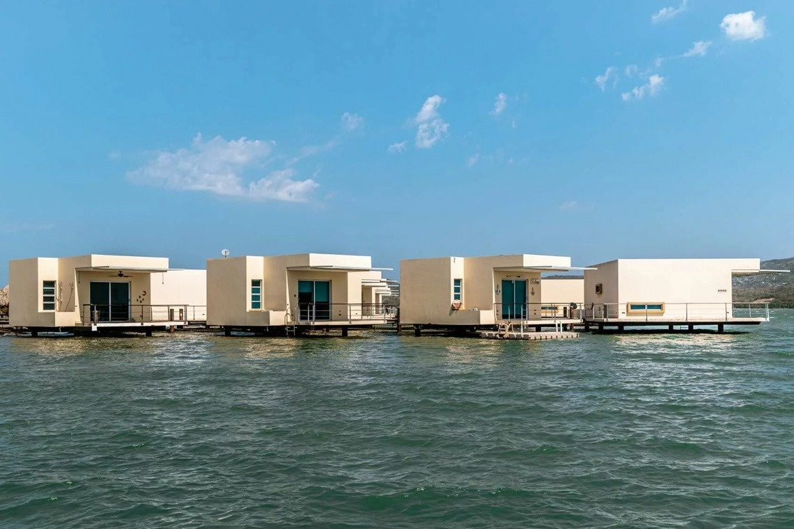 Modern floating bungalows at Marina Puerto Velero, turquoise sea views.