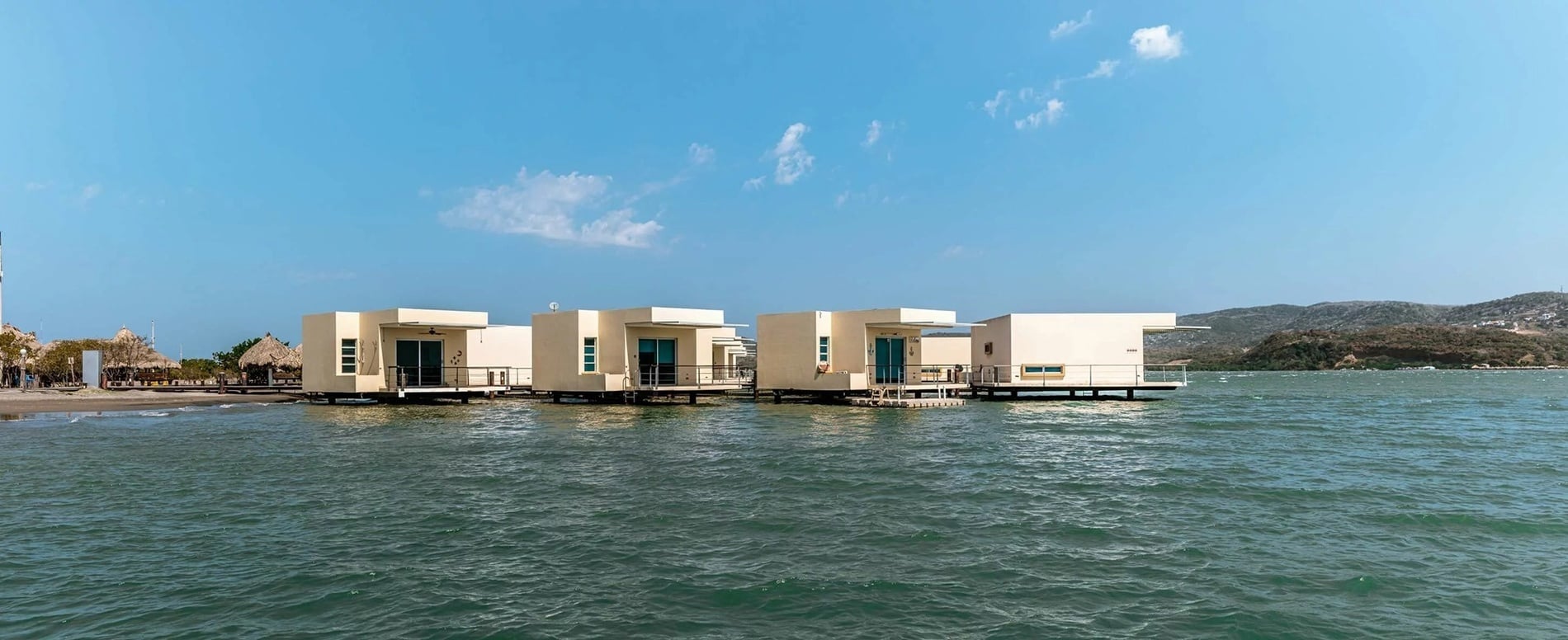 Modern overwater bungalows at Marina Puerto Velero, overlooking the Caribbean Sea.