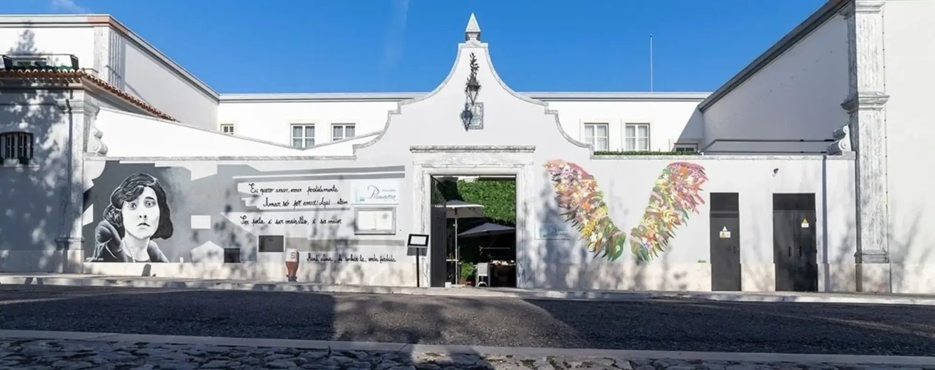 a white building with a painting of a woman on the side