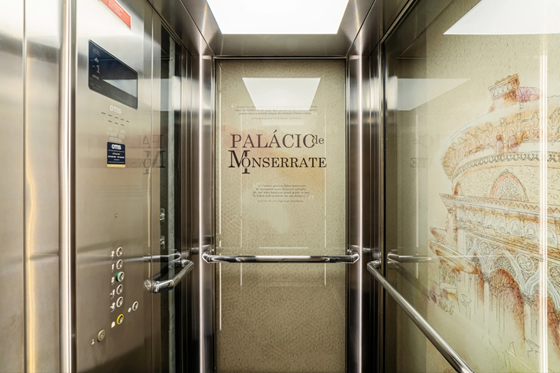 Modern hotel elevator with ornate Monserrate Palace Marmoris Hotels graphics.