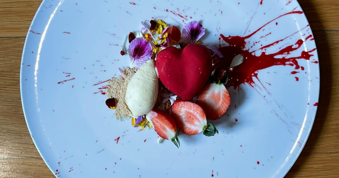 a white plate with a heart shaped dessert on it