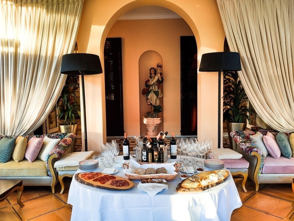 a table with bottles of wine and bread on it