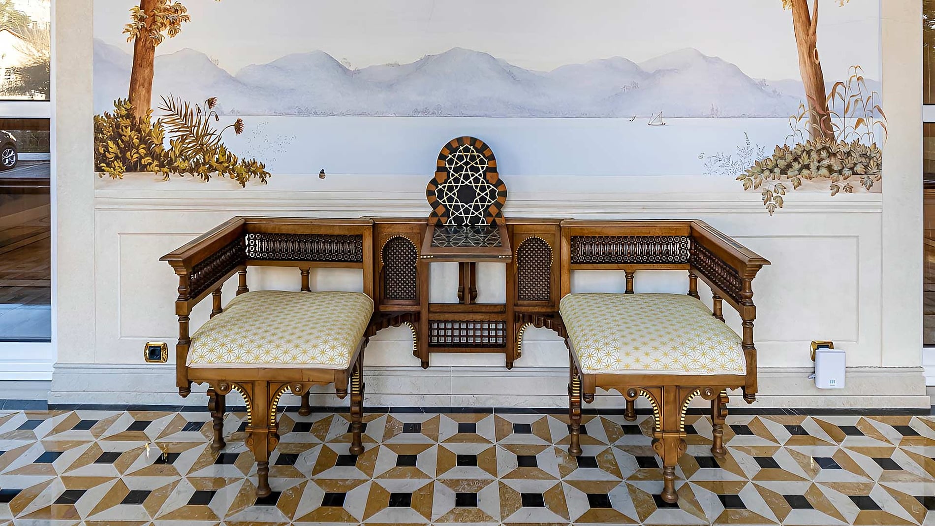 Hotel reception desk with a scenic mural of a balcony and lake Offers | Sintra Marmòris Palace | Sintra | Portugal view.