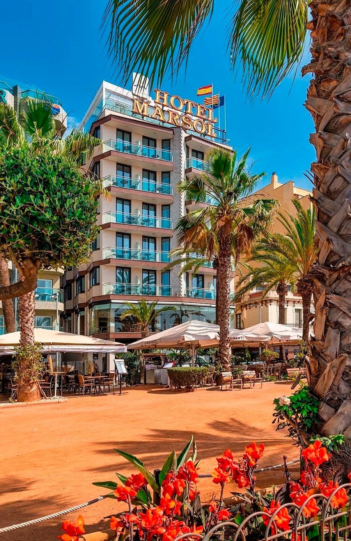Hotel Marsol en Lloret de Mar: Fachada moderna con palmeras y terraza.