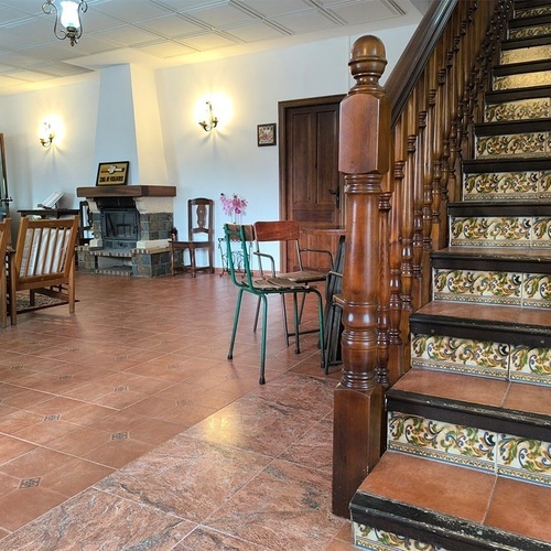 a living room with a fireplace and stairs leading up to it