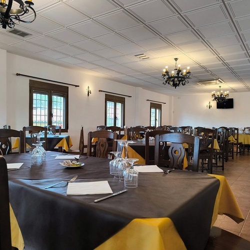 a dining room with tables and chairs and a chandelier