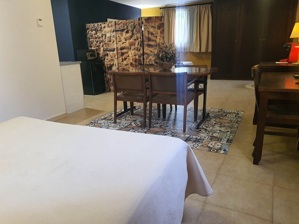 una habitación con una cama y una mesa y sillas