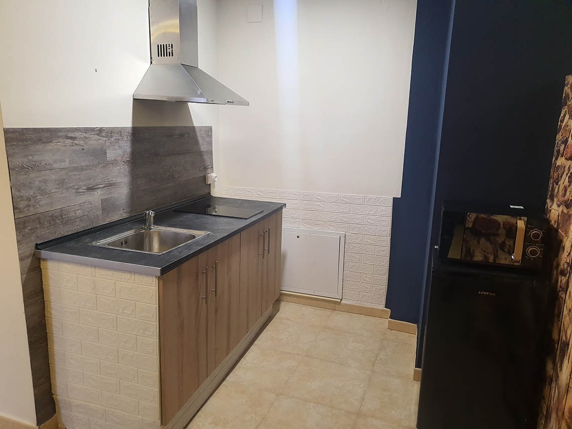 una cocina pequeña con un fregadero y una estufa