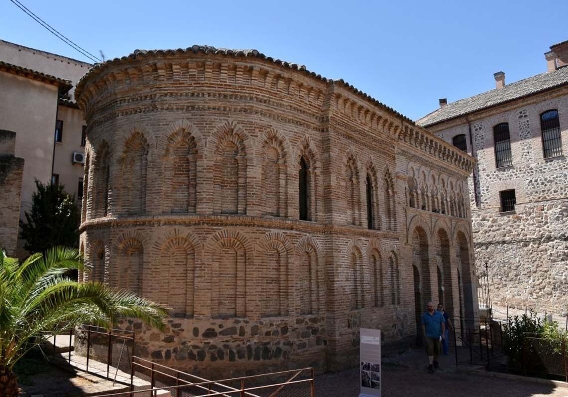 a large building with a steeple in the middle of a city