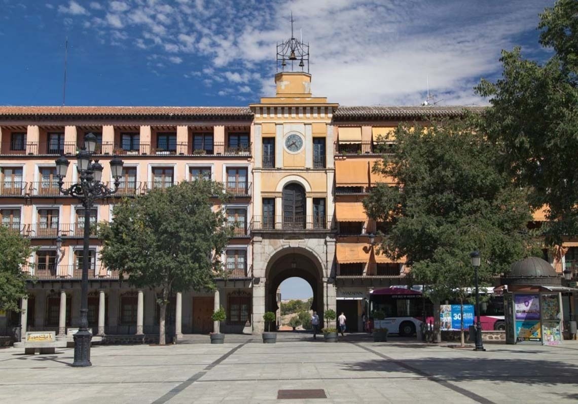 a large building with a steeple in the middle of a city