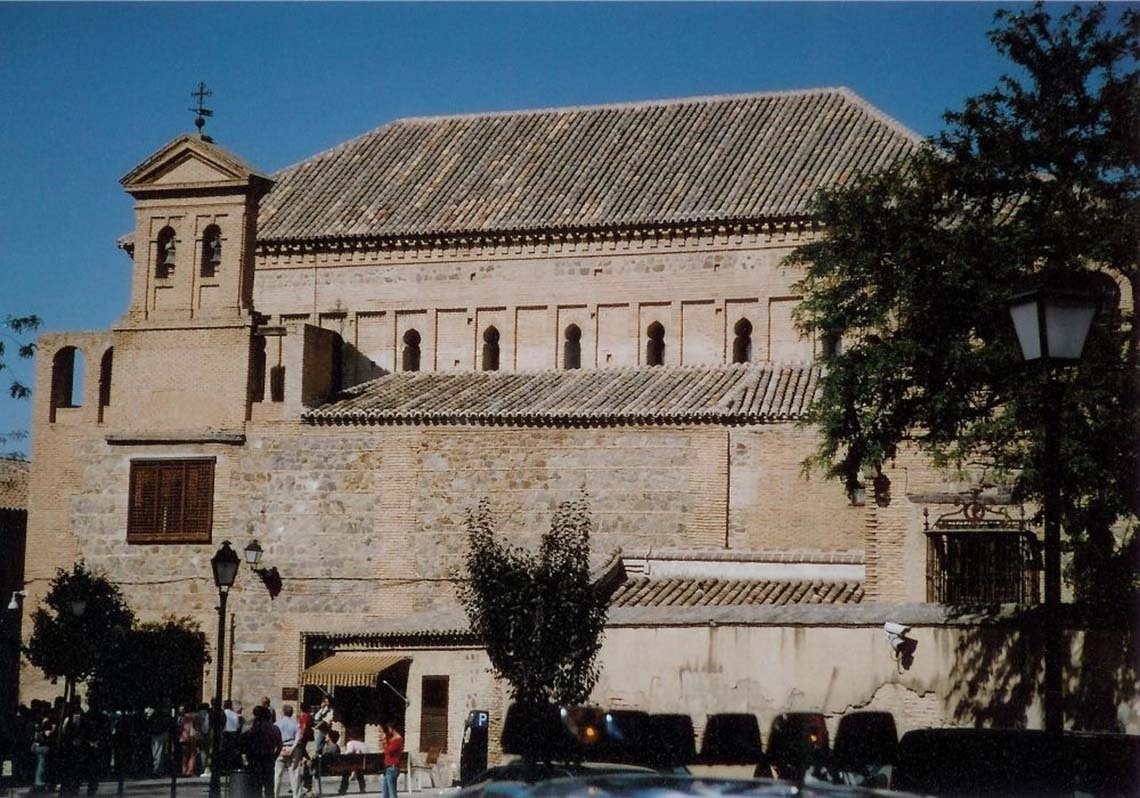 a large building with a steeple in the middle of a city