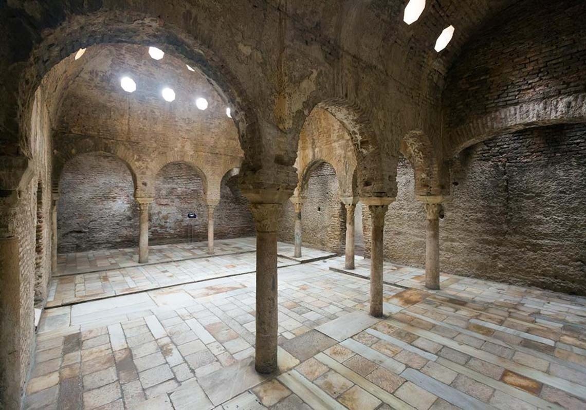 a large building with a steeple in the middle of a city