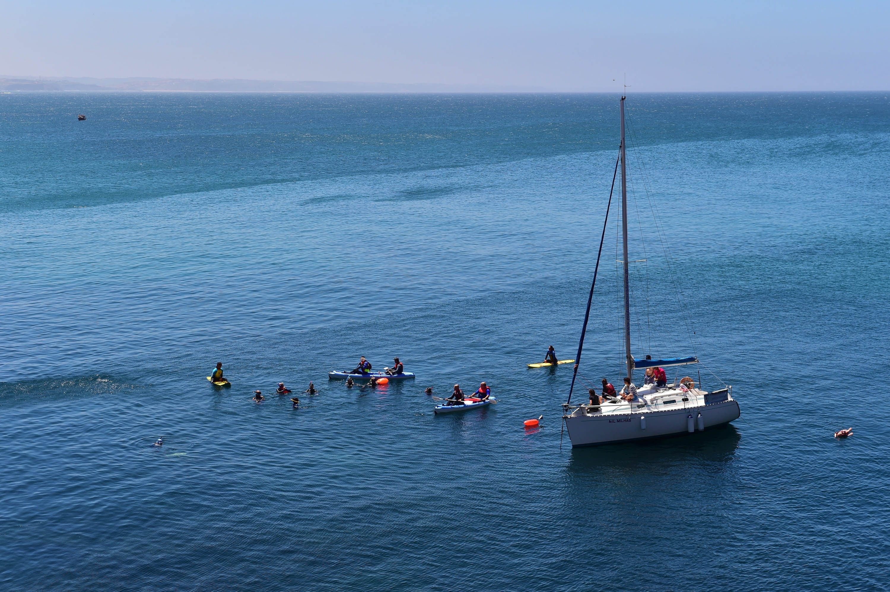 a sailboat is floating on top of a large body of water .