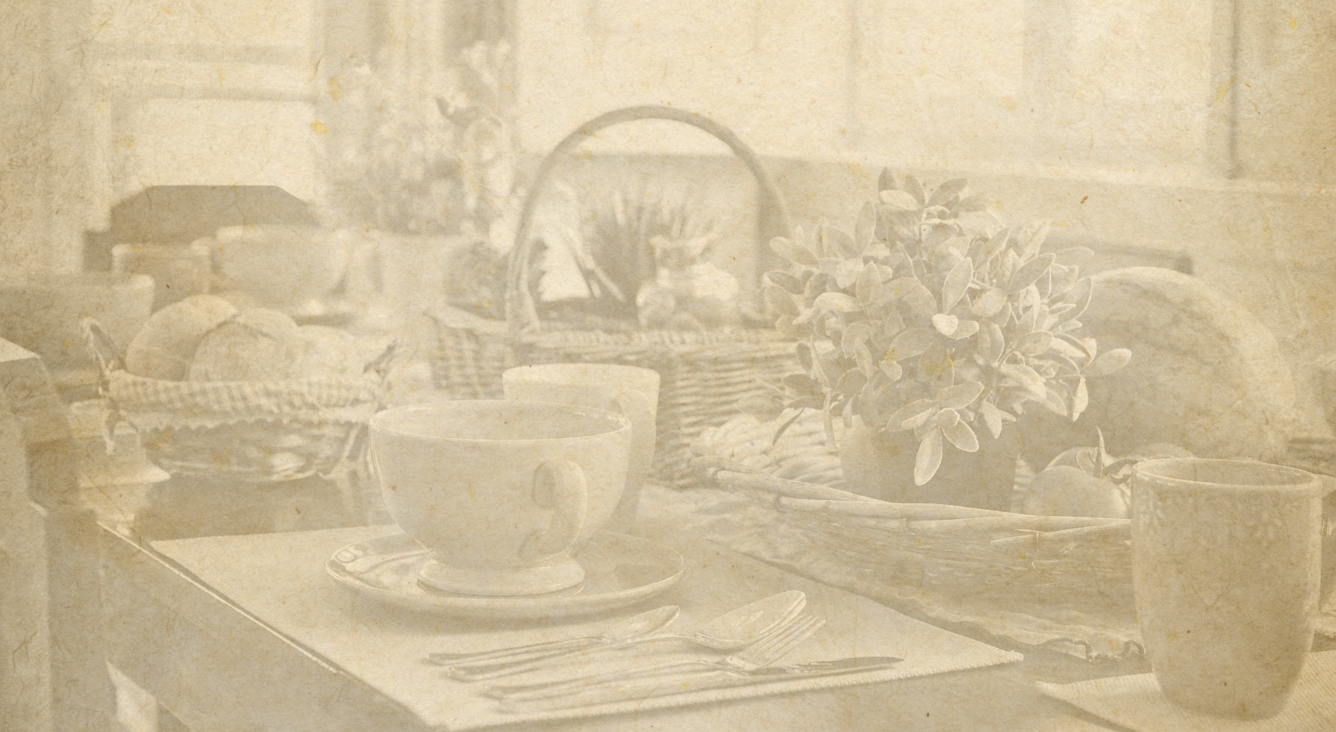 uma foto em preto e branco de uma mesa com pratos e talheres=s1900