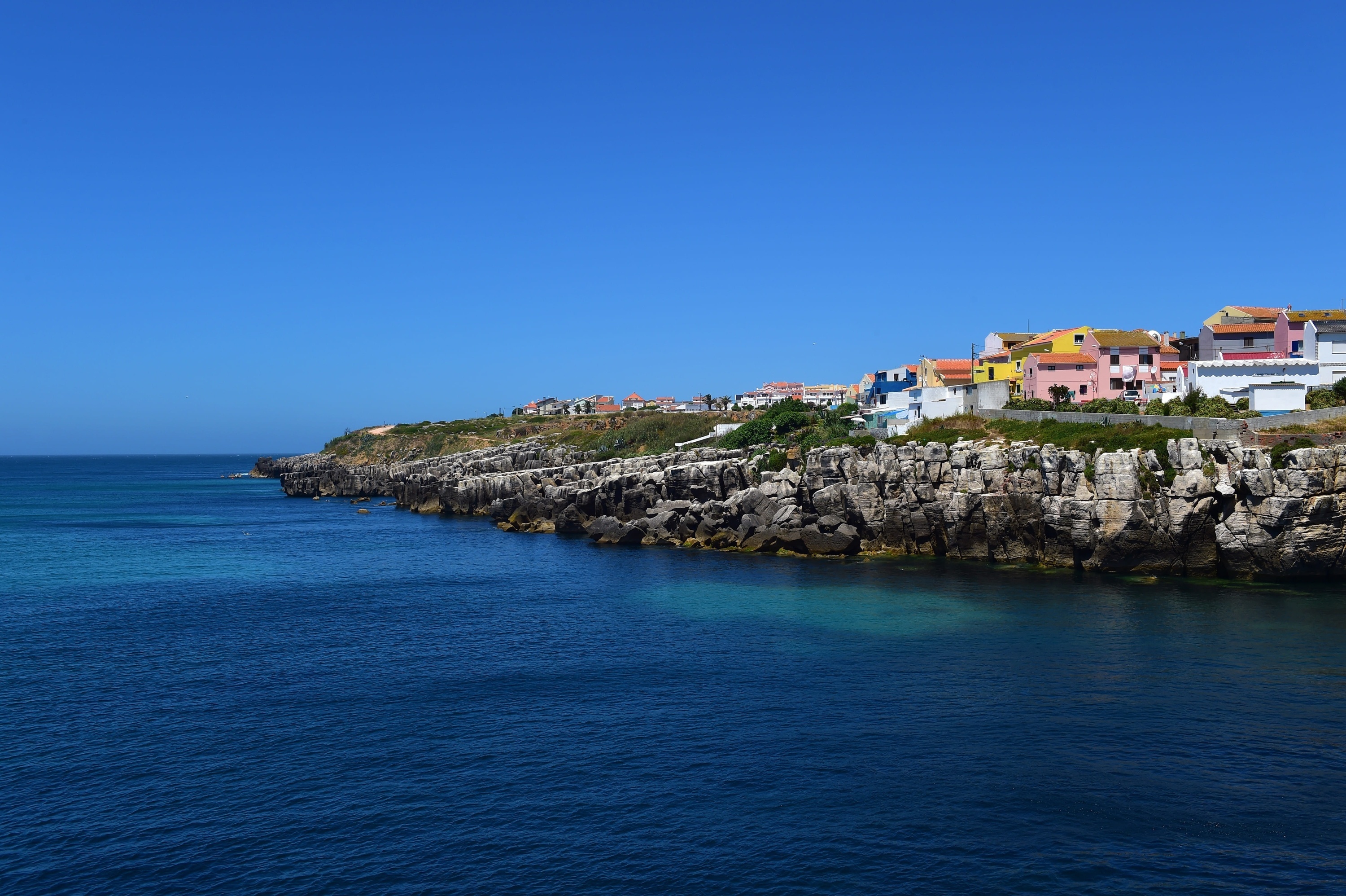 a small town on a rocky cliff overlooking the ocean .