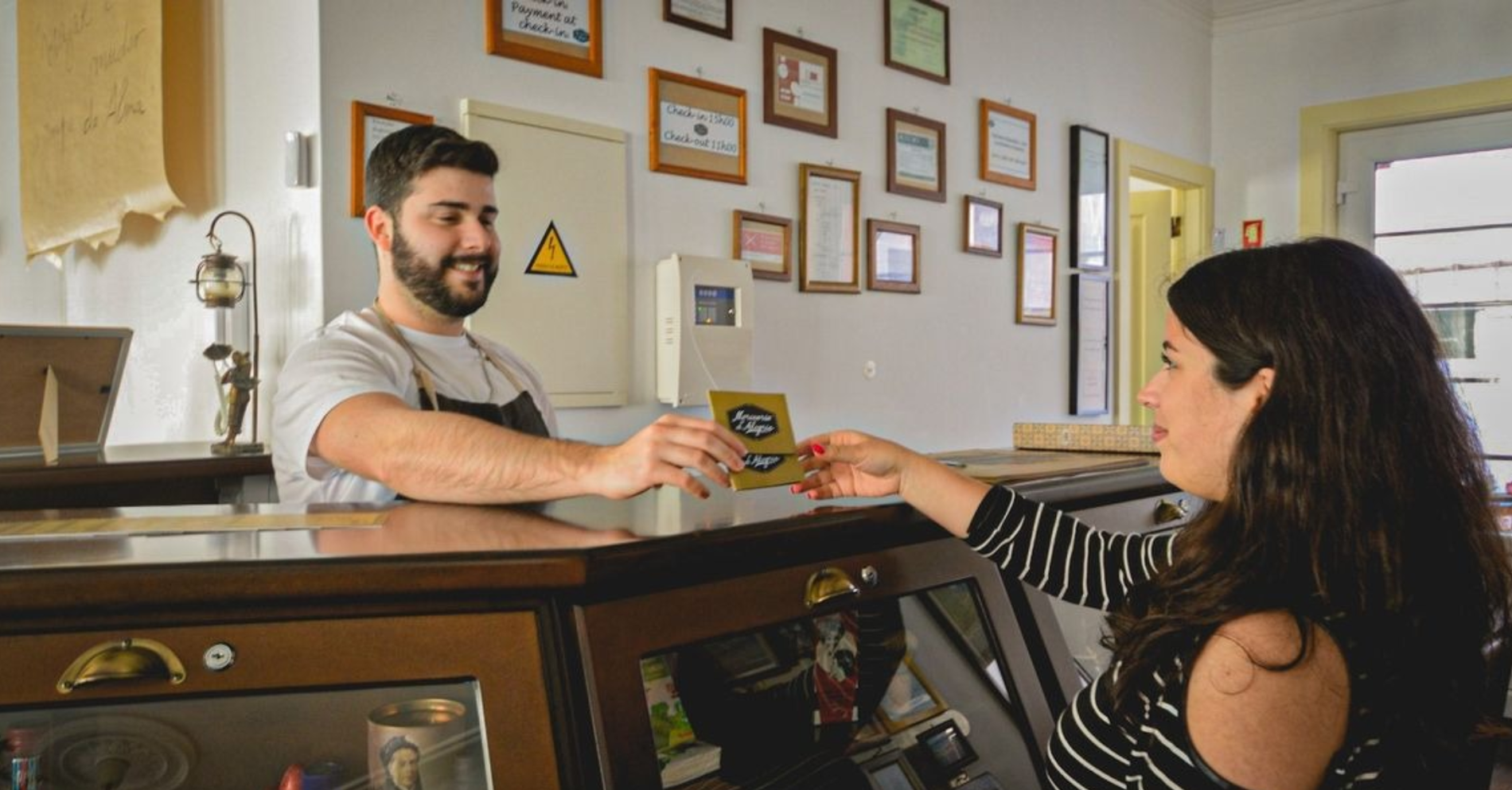 a room with chairs and a table with a chandelier on the wall