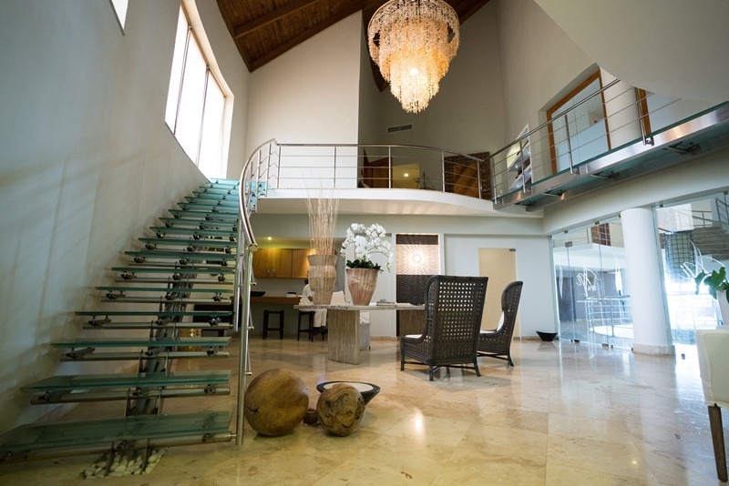 a glass staircase with a chandelier hanging from the ceiling