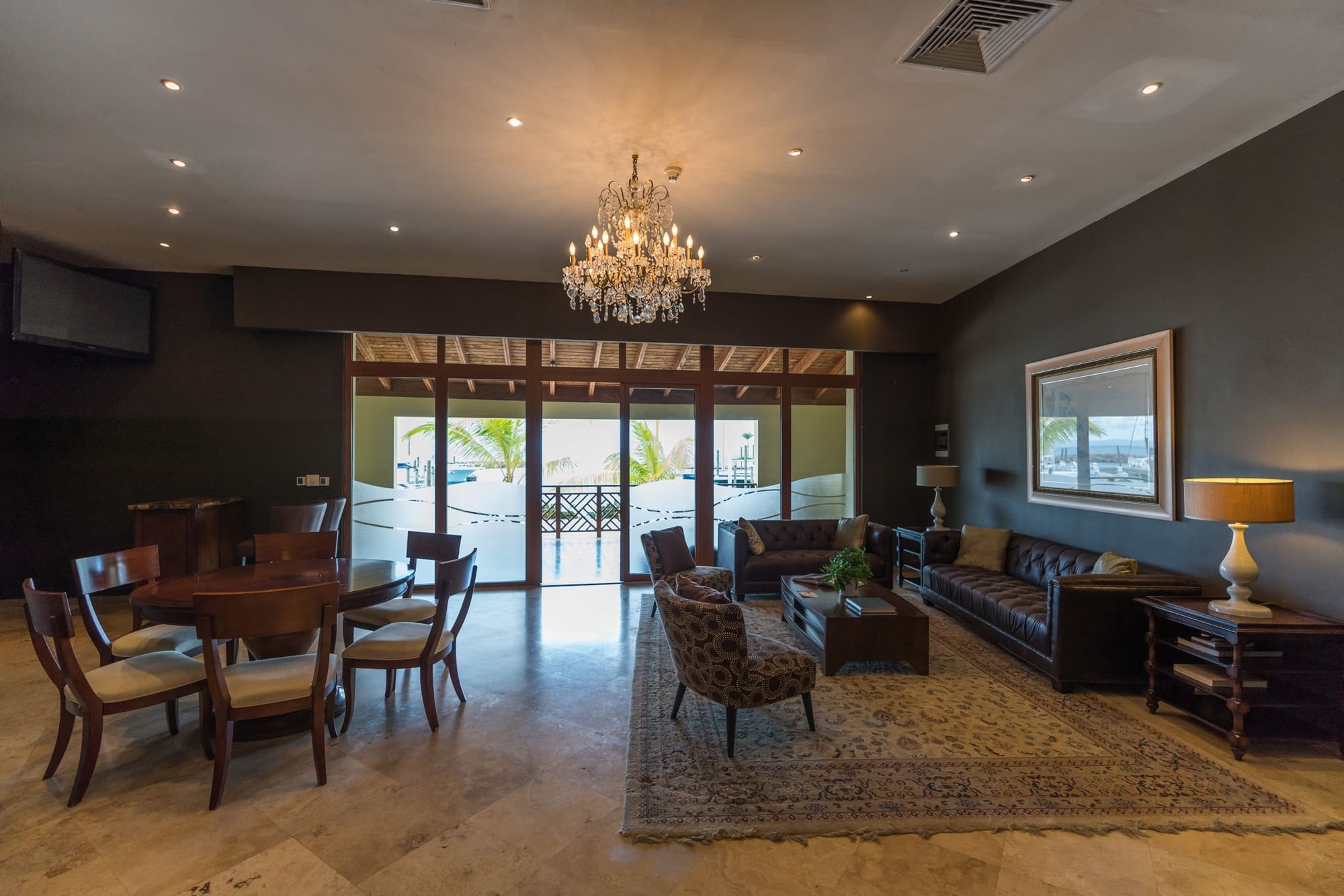 a living room with a chandelier hanging from the ceiling