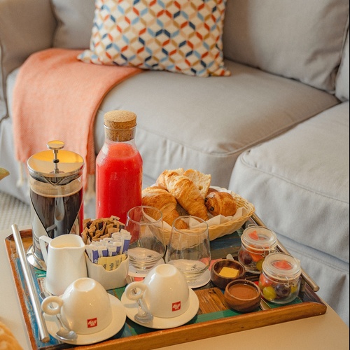 a tray with illy coffee cups and croissants on it
