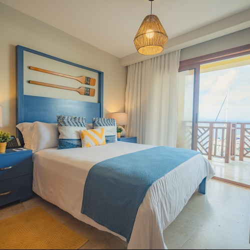 a bedroom with a large bed and a blue headboard