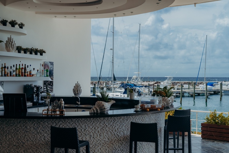 a bar with a view of boats in a marina