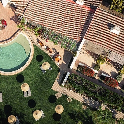 an aerial view of a large house with a swimming pool