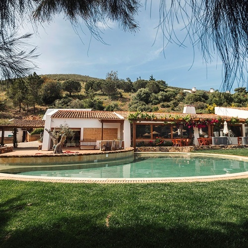 a house with a large swimming pool in front of it