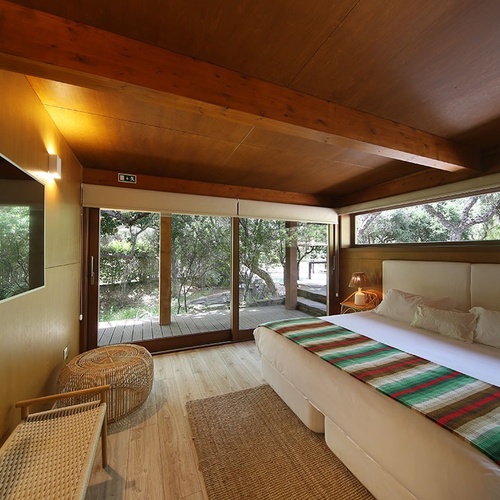 a bedroom with a large bed and a sliding glass door
