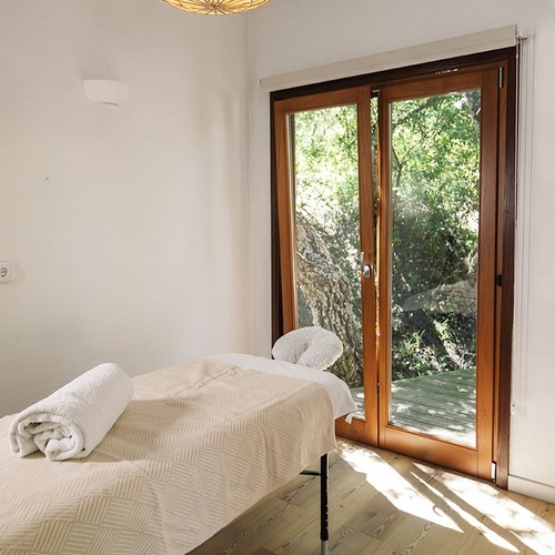 a massage table in a room with a large window