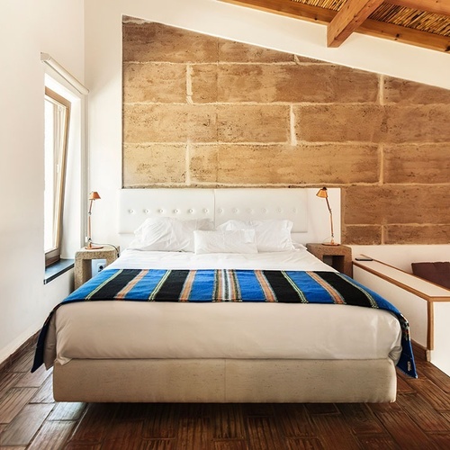 a bedroom with a large bed and a large window