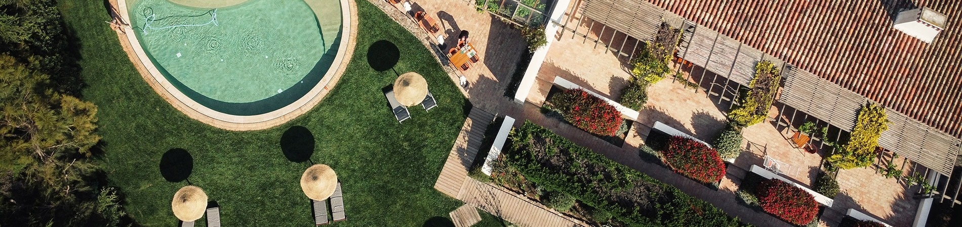 an aerial view of a house with a large swimming pool