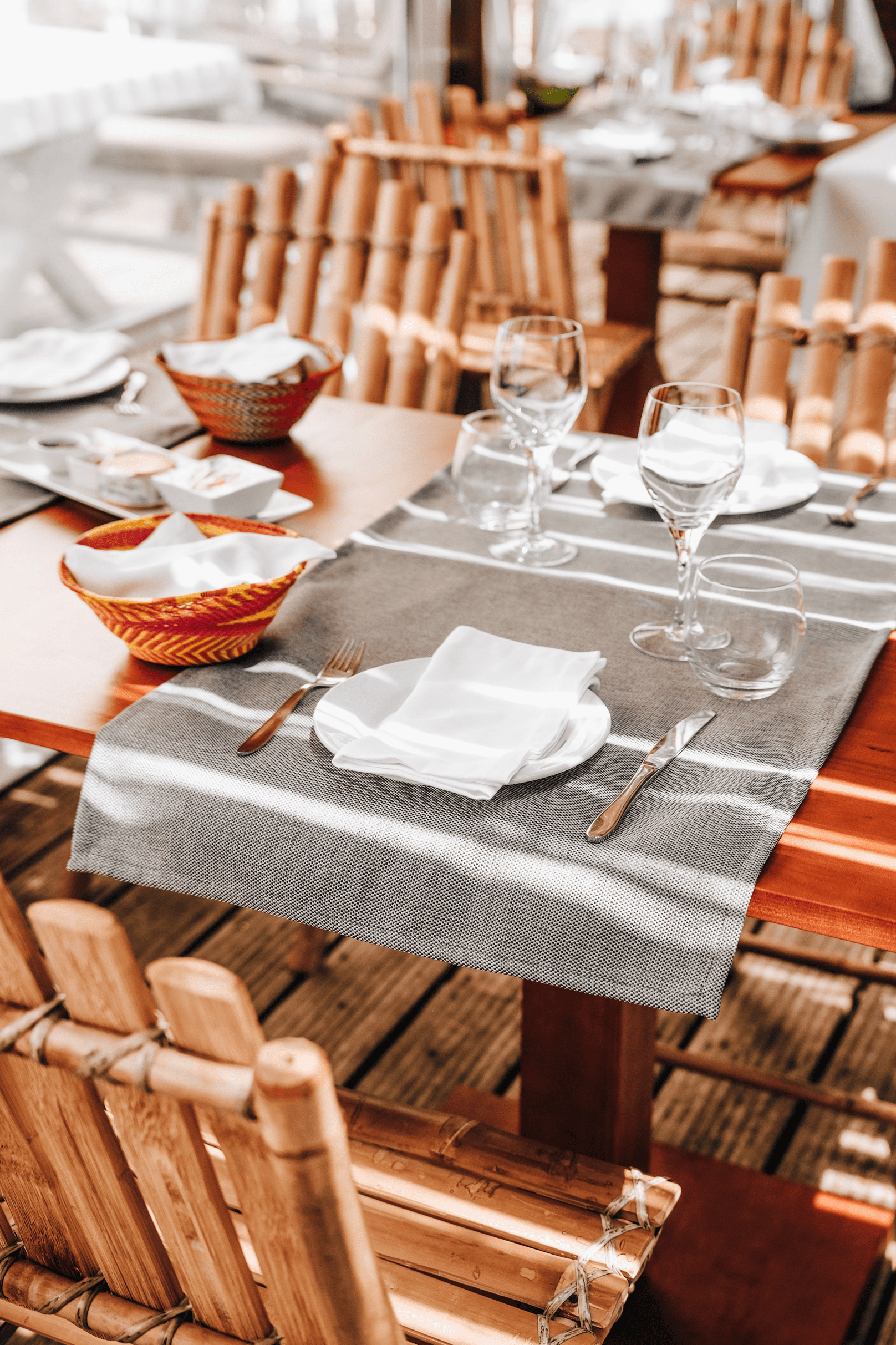 a wooden table with plates and glasses on it