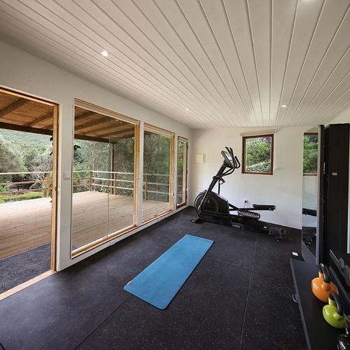 a gym with a blue yoga mat on the floor