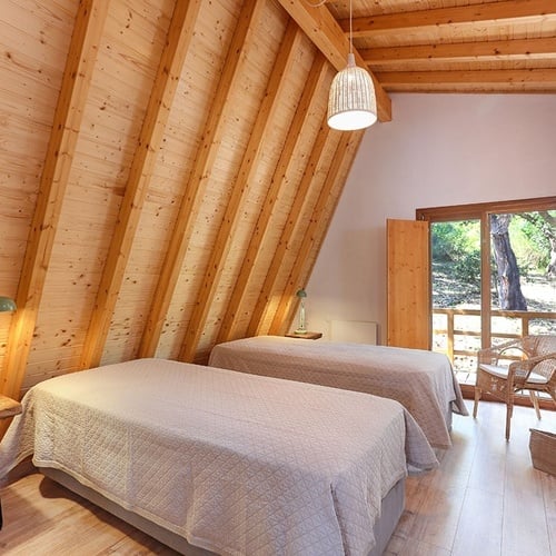 a bedroom with two beds and a green lamp