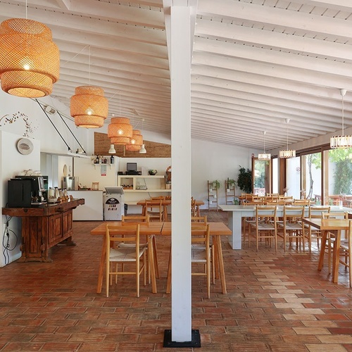 a dining room with tables and chairs and a coffee machine