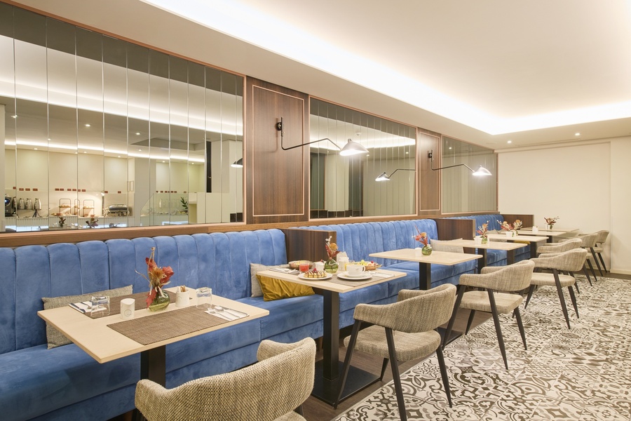 a dining room with tables and chairs and blue benches