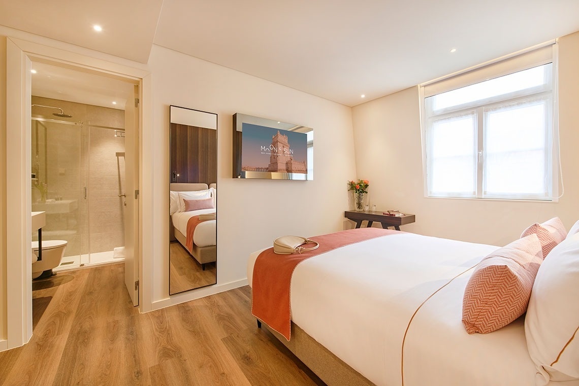 a hotel room with a bed and a picture of the tower bridge on the wall