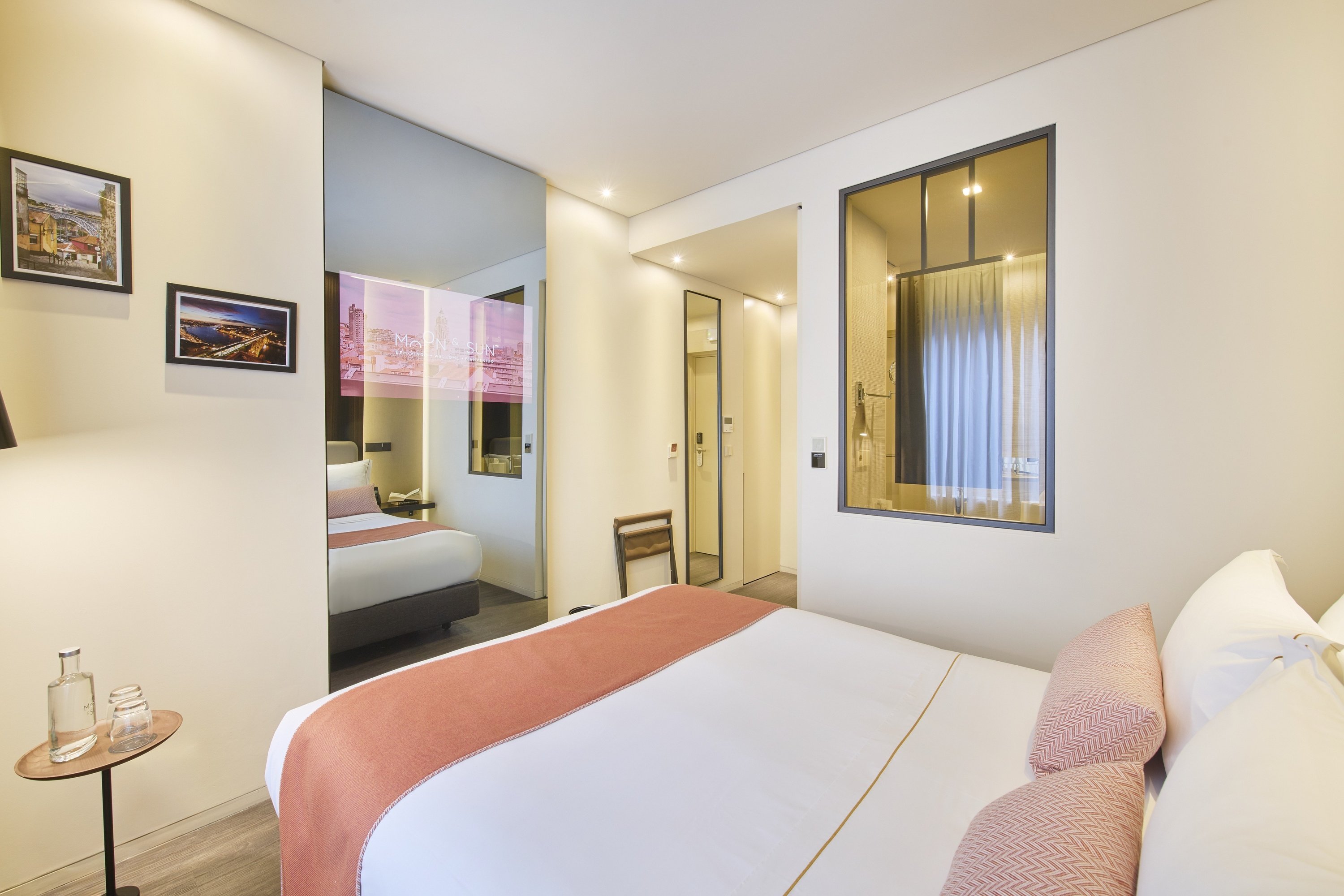a hotel room with a bed and a mirror