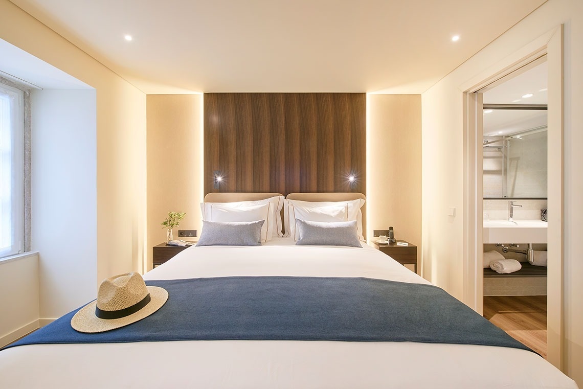 a hotel room with a bed and a hat on the bed