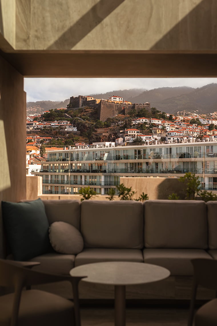 Rooftop lounge view of a historic fortress overlooking a modern hotel. Moon & Sun: Corpo
