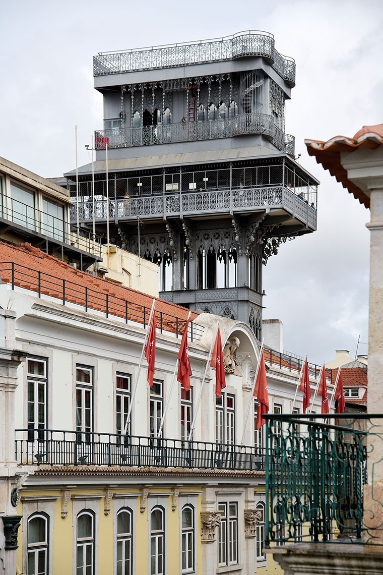 un edificio con banderas rojas y blancas y un elevador en el fondo