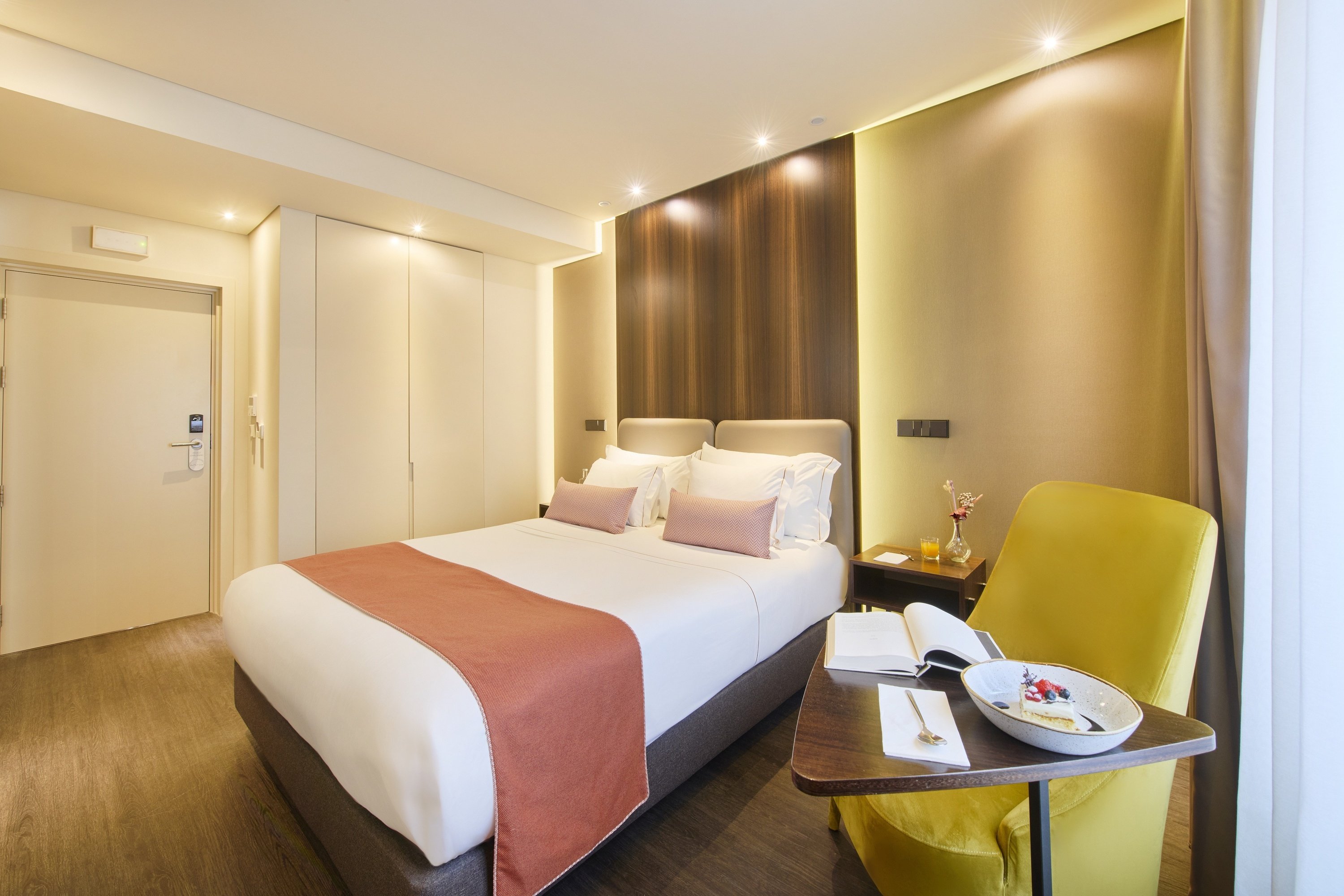 a hotel room with a bed and a chair