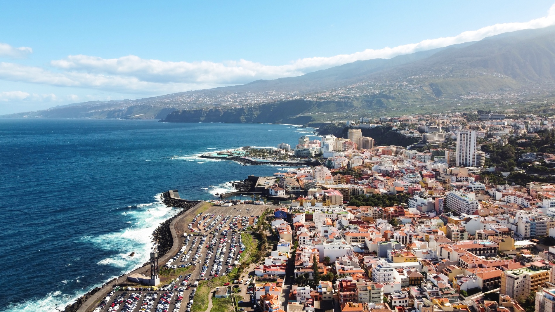 Coastal town with ocean views and buildings, About Us | Moon & Sun Funchal.