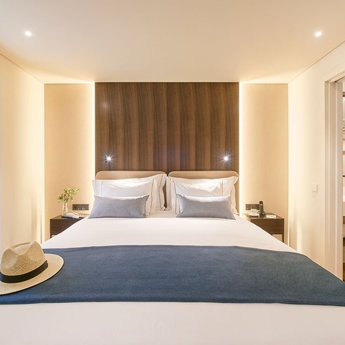 a hotel room with a bed and a hat on the bed