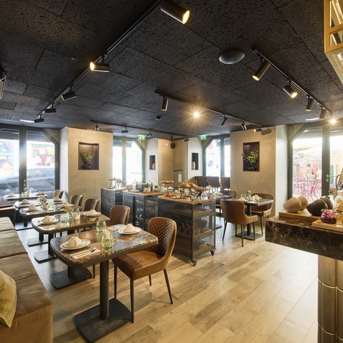 a restaurant with tables and chairs and a buffet