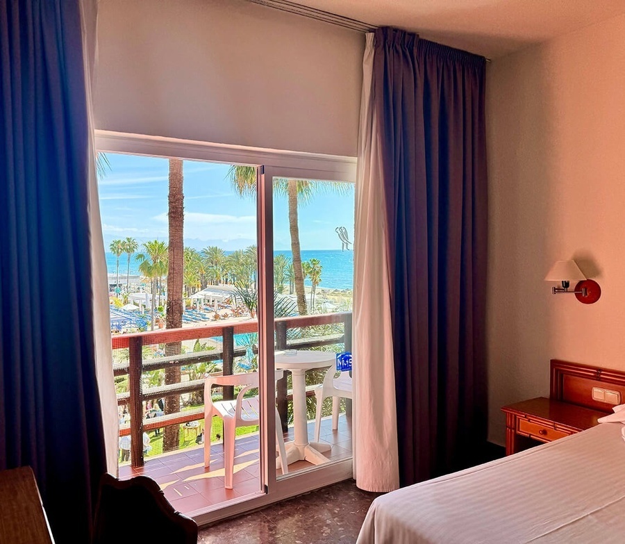 a hotel room with a view of the ocean