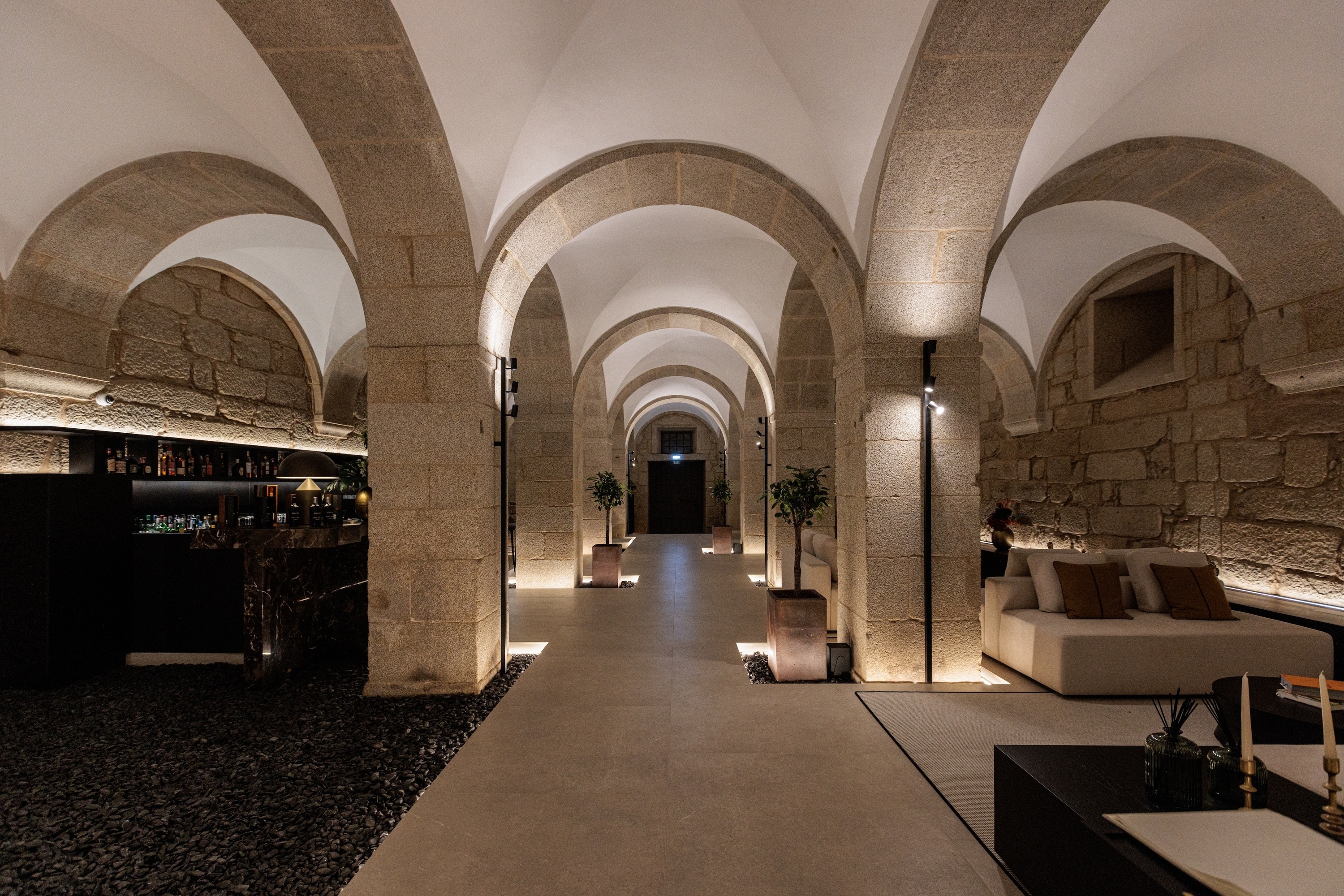 a long hallway with arched ceilings and stone pillars