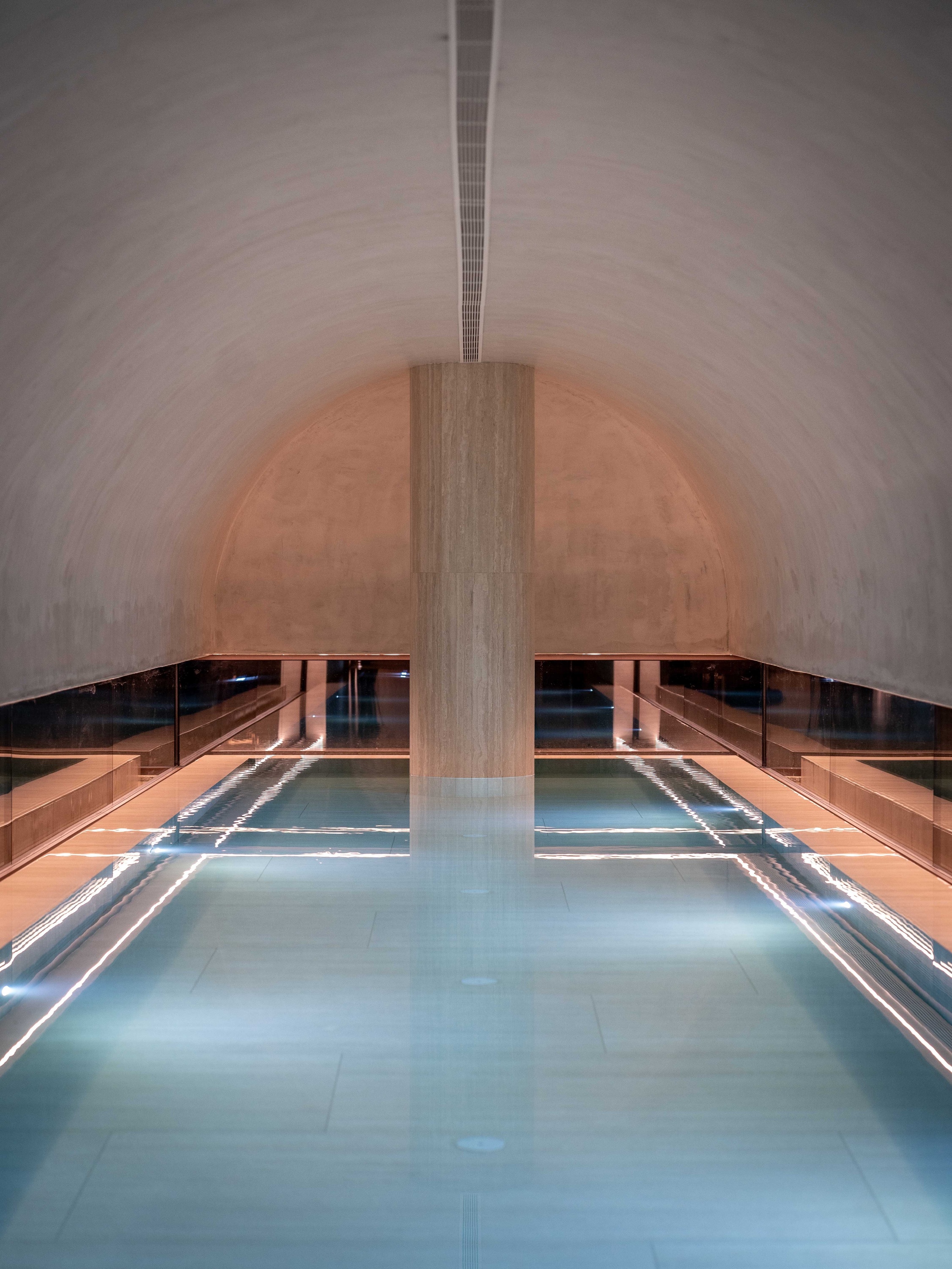 a swimming pool in a room with a sliding glass door