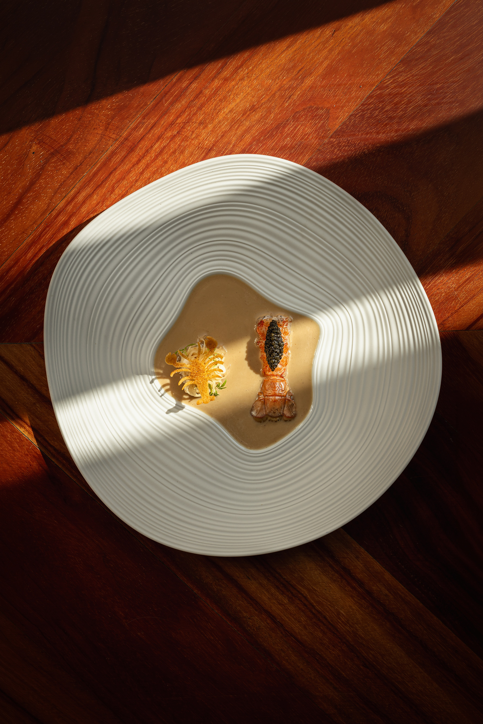 Gourmet lobster tail with caviar and garnishes on a white plate, perfect for MS collection: corpo dining.